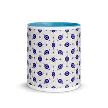 Load image into Gallery viewer, 11 oz. white ceramic coffee/tea mug with solid light blue handle, rim, and inside. Wrapped around mug is patterned image of eye of protection/evil eye. Outside middle view.
