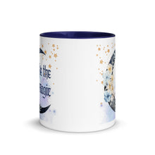 Load image into Gallery viewer, 11 oz. white ceramic coffee/tea mug with solid navy blue handle, rim, and inside. Image Design: watercolor blue crescent moon, with flowers, daisies, lilies, butterflies. Stars in background, smoky purple background. Image phrase: Be the Magic. Center front view. Halloween, spooky season.
