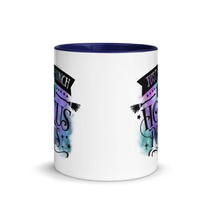 11 oz. white ceramic coffee/tea mug with solid navy blue handle, rim, and inside. Image Design: phrase "just a bunch of Hocus Pocus, with mini image of pumpkin and broom,  whimsical font. backed by blue and purple cosmic cloud. Image phrase: Just a bunch of Hocus Pocus. Center front view. Halloween, spooky season.