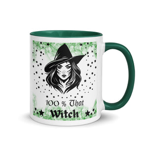 11 oz. white ceramic coffee/tea mug with solid dark green handle, rim, and inside. Image Design: Beautiful witch svg, with stars bordering her face and hat, wispy green smoke in background. Image phrase: 100% That Witch. Right hand side view. Halloween, spooky season.