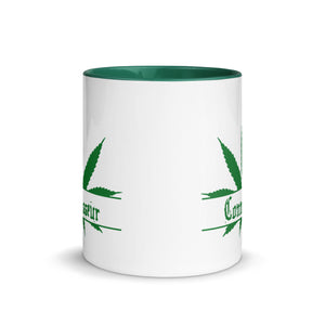 Ceramic coffee/tea mug with solid dark green handle, rim, and inside. Image Design: Marijuana leaf with "Connoisseur" text. Outside middle view.