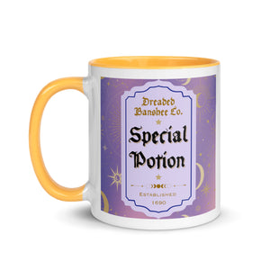 11 oz. white ceramic coffee/tea mug with solid golden yellow handle, rim, and inside. Image Design: potion label that says 'Special Potion' with brand name above 'Dreaded Banshee Co., established 1690.' Purple-bluish background color with motif of suns, crescent moons, stars, constellations. Image phrase: Special Potion. Left hand side view. Halloween, spooky season.