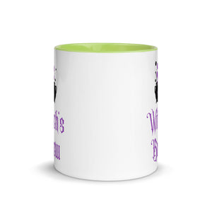 11 oz. white ceramic coffee/tea mug with solid light green handle, rim, and inside. Image Design: above image phrase, black cauldron with purple smoke, crescent moon on cauldron. Image phrase: Witch's brew. Center front view. Halloween, spooky season.