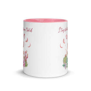 11 oz. white ceramic coffee/tea mug with solid light pink handle, rim, and inside. Image Design: Moon phases, colorful pink and green tinged cacti, with "Stay Wild Moon Child" text. Front center view.