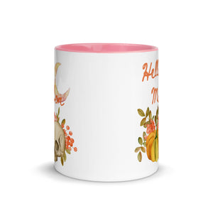 11 oz. white ceramic coffee/tea mug with solid light pink handle, rim, and inside. Image Design:  watercolor pumpkin, and skull, leaves and berries behind. Crescent moon in background. Image phrase: Hello Mabon. Center front view. Halloween, spooky season.