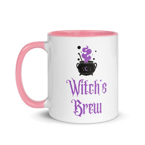 11 oz. white ceramic coffee/tea mug with solid light pink handle, rim, and inside. Image Design: above image phrase, black cauldron with purple smoke, crescent moon on cauldron. Image phrase: Witch's brew. Left hand side view. Halloween, spooky season.