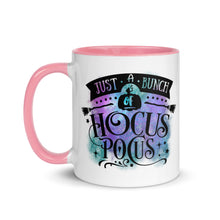 Load image into Gallery viewer, 11 oz. white ceramic coffee/tea mug with solid light pink handle, rim, and inside. Image Design: phrase &quot;just a bunch of Hocus Pocus, with mini image of pumpkin and broom,  whimsical font. backed by blue and purple cosmic cloud. Image phrase: Just a bunch of Hocus Pocus. Left hand side view. Halloween, spooky season.
