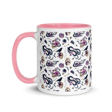 Load image into Gallery viewer, 11 oz. white ceramic coffee/tea mug with solid pink handle, rim, and inside. Image Design: gothic theme patter of skulls, wands, snakes, ravens, purple flowers. left hand side view. 
Halloween, spooky season.
