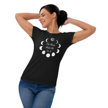 Load image into Gallery viewer, Woman modeling/wearing Woman&#39;s black t-shirt with image phrase: The moon made me do it. Bordered with Moon phases. Front view. Halloween, spooky season.
