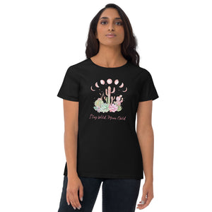 woman wearing/modeling women's black t-shirt with image design of Moon phases, cacti and flowers, and "Stay Wild Moon Child" text