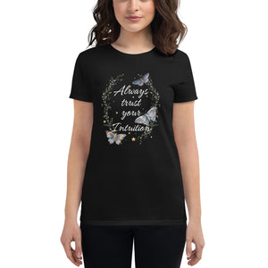 woman modeling/wearing women's black t-shirt. Image Design: Text "Always trust your Intuition," with plant/vine border, watercolor style moths, stars