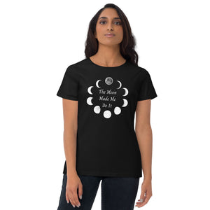 Woman modeling/wearing Woman's black t-shirt with image phrase: The moon made me do it. Bordered with Moon phases. Front view. Halloween, spooky season.