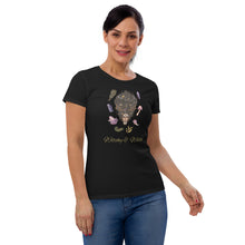 Load image into Gallery viewer, Woman modeling/wearing woman&#39;s black t-shirt with image phrase: Witchy &amp; Wild, with image of woman&#39;s head with antlers, and stars in her hair. Circling her head are crystals, frog, snail, fern leaf, bunch of flowers, mushroom. Front view. Halloween, spooky season.
