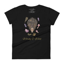 Load image into Gallery viewer, Woman&#39;s black t-shirt with image phrase: Witchy &amp; Wild, with image of woman&#39;s head with antlers, and stars in her hair. Circling her head are crystals, frog, snail, fern leaf, bunch of flowers, mushroom. Front view. Halloween, spooky season.
