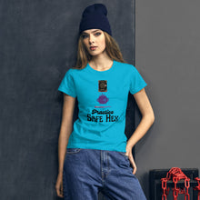 Load image into Gallery viewer, Woman modeling/wearing woman&#39;s light blue t-shirt with image phrase: Practice safe Hex (play on words for &#39;Practice safe sex.&#39; Above phrase is a spell book, a cauldron, a wand. Front view. Halloween, spooky season.
