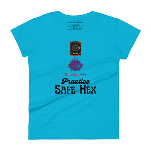 Woman's light blue t-shirt with image phrase: Practice safe Hex (play on words for 'Practice safe sex.' Above phrase is a spell book, a cauldron, a wand. Front view. Halloween, spooky season.