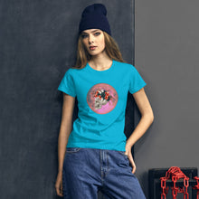 Load image into Gallery viewer, woman modeling/wearing women&#39;s caribbean blue t-shirt, with image design: side profile of a skull wearing a crown/hat of black roses, red poppies, thorny vines, and white butterflies, with a pink-red moon behind it. Front View.
