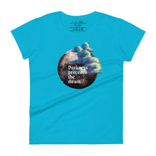 Load image into Gallery viewer, women&#39;s caribbean blue t-shirt with image design of a dark moon, with a colorful dawn cloud in front, with image phrase: &quot;Darkness precedes the Dawn.&quot; Front View.
