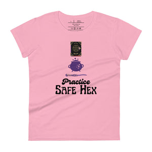 Woman's light pink t-shirt with image phrase: Practice safe Hex (play on words for 'Practice safe sex.' Above phrase is a spell book, a cauldron, a wand. Front view. Halloween, spooky season.