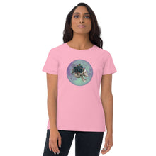 Load image into Gallery viewer, woman modeling/wearing women&#39;s charity pink t-shirt, with image design: side profile of a skull wearing a crown/hat of black roses, red berries, thorny vines and leaves, with a blue-purple moon behind it. Front View.
