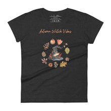 Load image into Gallery viewer, Woman&#39;s dark heather grey t-shirt with image phrase in light orange font: Autumn Witch Vibes, with image of picturebook witch hat adorned with brown vines, autumn leaves, red-orange berries. A circle of leaves, acorns, pinecone, daisy flower, and mushroom, encircled the hat. Front view. Halloween, spooky season.
