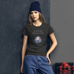 woman modeling/wearing women's heather dark grey t-shirt, with image phrase: "The quiet mind hears the Universe." Image of watercolor pink and blue lotus flower floating on water.