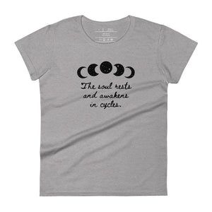 women's heather grey t-shirt, with image of black celestial moon phases, with star cut outs, and image phrase "The soul rests and awakens in cycles." Front view.