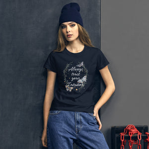 woman modeling/wearing women's navy blue t-shirt. Image Design: Text "Always trust your Intuition," with plant/vine border, watercolor style moths, stars