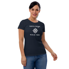 Load image into Gallery viewer, Woman modeling/wearing woman&#39;s navy blue t-shirt with image phrase: thick thighs, witch vibes. Witch&#39;s knot, with crescent moons, and star in the middle. Front view. Halloween, spooky season.
