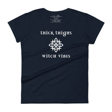 Load image into Gallery viewer, Woman&#39;s navy blue t-shirt with image phrase: thick thighs, witch vibes. Witch&#39;s knot, with crescent moons, and star in the middle. Front view. Halloween, spooky season.
