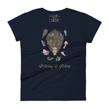 Load image into Gallery viewer, Woman&#39;s navy blue t-shirt with image phrase: Witchy &amp; Wild, with image of woman&#39;s head with antlers, and stars in her hair. Circling her head are crystals, frog, snail, fern leaf, bunch of flowers, mushroom. Front view. Halloween, spooky season.
