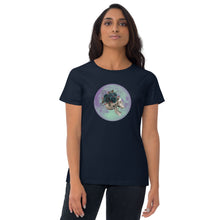 Load image into Gallery viewer, woman modeling/wearing women&#39;s navy blue t-shirt, with image design: side profile of a skull wearing a crown/hat of black roses, red berries, thorny vines and leaves, with a blue-purple moon behind it. Front View.
