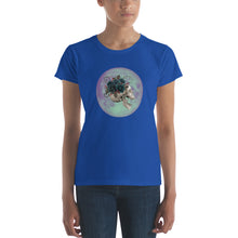 Load image into Gallery viewer, woman modeling/wearing women&#39;s royal blue t-shirt, with image design: side profile of a skull wearing a crown/hat of black roses, red berries, thorny vines and leaves, with a blue-purple moon behind it. Front View.
