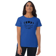 Load image into Gallery viewer, woman modeling/wearing women&#39;s royal blue t-shirt, with image of black celestial moon phases, with star cut outs, and image phrase &quot;The soul rests and awakens in cycles.&quot; Front view.
