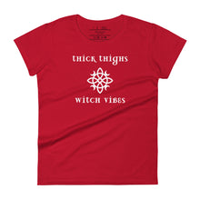 Load image into Gallery viewer, Woman&#39;s red t-shirt with image phrase: thick thighs, witch vibes. Witch&#39;s knot, with crescent moons, and star in the middle. Front view. Halloween, spooky season.
