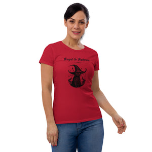 Woman modeling/wearing woman's red t-shirt with image phrase: Magical & Mischievous, with image of black cat wearing a black hat underneath. Front view. Halloween, spooky season.