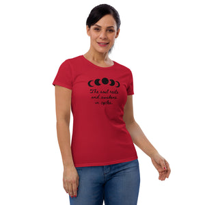 woman modeling/wearing women's red t-shirt, with image of black celestial moon phases, with star cut outs, and image phrase "The soul rests and awakens in cycles." Front view.