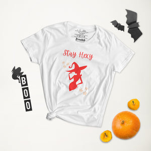 Woman's white t-shirt with image phrase: Stay Hexy (play on words for Stay Sexy), red silhouette of pretty witch form, pentacle stars on both side. Front view. Halloween, spooky season.