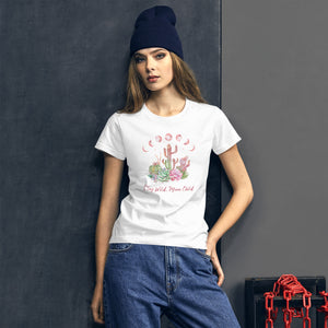 woman modeling/wearing women's white t-shirt with image design of Moon phases, cacti and flowers, and "Stay Wild Moon Child" text