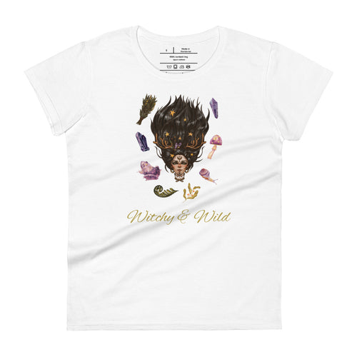 Woman's white t-shirt with image phrase: Witchy & Wild, with image of woman's head with antlers, and stars in her hair. Circling her head are crystals, frog, snail, fern leaf, bunch of flowers, mushroom. Front view. Halloween, spooky season.