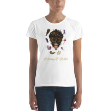 Load image into Gallery viewer, Woman modeling/wearing woman&#39;s white t-shirt with image phrase: Witchy &amp; Wild, with image of woman&#39;s head with antlers, and stars in her hair. Circling her head are crystals, frog, snail, fern leaf, bunch of flowers, mushroom. Front view. Halloween, spooky season.
