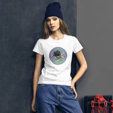 Load image into Gallery viewer, woman modeling/wearing women&#39;s white t-shirt, with image design: side profile of a skull wearing a crown/hat of black roses, red berries, thorny vines and leaves, with a blue-purple moon behind it. Front View.
